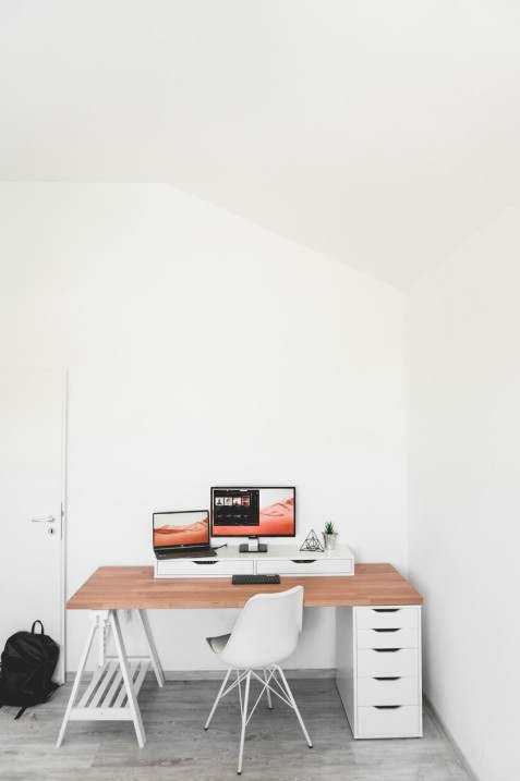 Multiple sit-stand desks in open plan